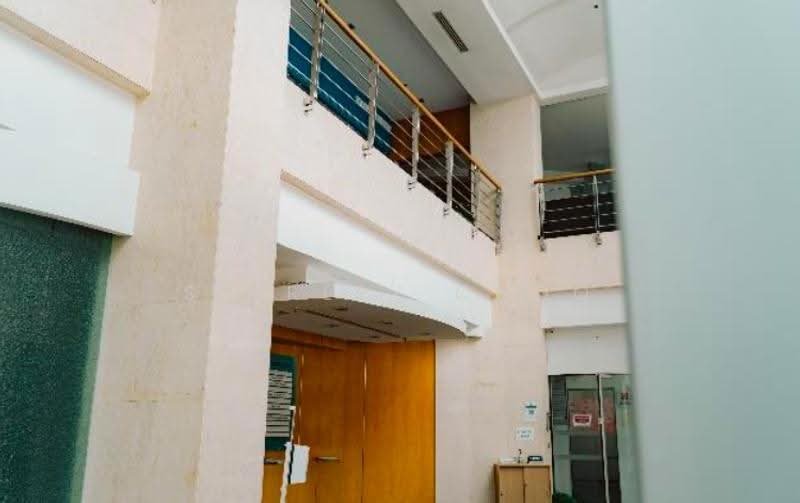 Double-volume atrium lobby with wooden doors, photo 2 of 5